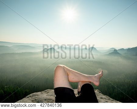 Crossed Male Barefoot Legs Of Man Relax On Mountain Summit. Hiker Lay Down And Have A Rest