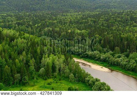 Top View Of A Wild Wooded River Valley Among The Hills
