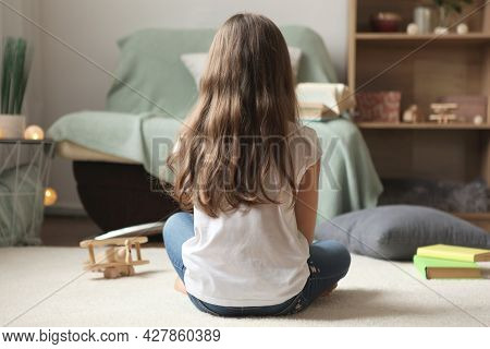 Lonely Sad Girl At Home. Saddened Alarmed Child Alone At Home.