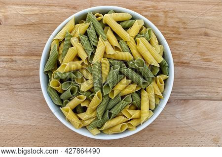Fresh Raw Colored Pasta. Italian Maccheroni Al Pettine On Wooden Table. View From Above