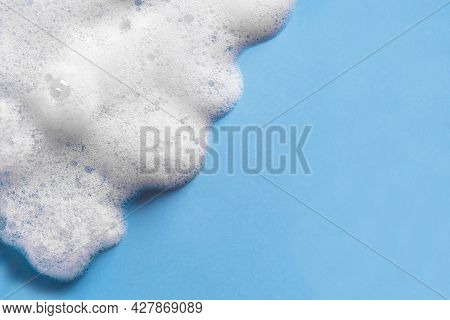 Face Cleansing Mousse Sample. White Cleanser Foam Bubbles On Blue Background, Copy Space. Soap, Show