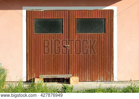 Makeshift Wooden Bench Made Of Two Building Bricks And Single Wooden Board In Front Of Dilapidated G