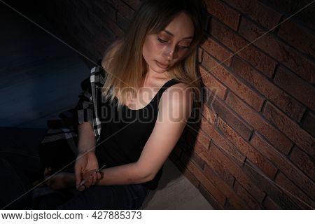 Overdosed Drug Addicted Woman Near Brick Wall