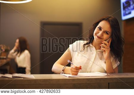 Brunette Woman Receptionist Working In Reception Of The Beauty Salon