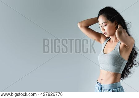 Asian Woman With Sexy Shapely Forms Posing In Trendy Look. Portrait Of A Brunette Model With Bright 