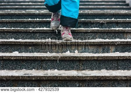 Closeup Photo Of Tourist Walking On Stairs On Cold Inter Day