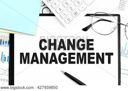 Text Change Management On Clipboard, Pen, Glasses, Calculator, Sticker, Graphs. Business Concept. Fl