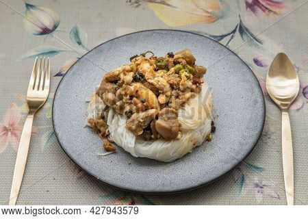 Green Curry With Chicken (kaeng Kheow Hwan With Chicken) On Top Of Soft Rice Noodle On Ceramic Plate