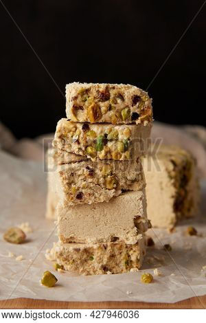 Organic Halva With Pistachios On A Wooden Surface. Traditional Middle Eastern Sweets. Jewish, turkis
