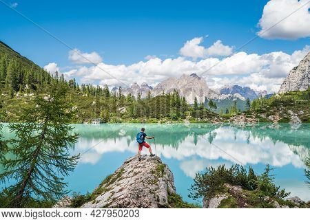 Backpacker With Backpack Enjoying The Turquoise Lago Di Sorapiss 1,925m Altitude (mountain Lake) Vie