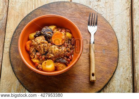 Jewish Dish Chelnt With Meat On The Table In A Plate On A Round Stand. Horizontal Photo