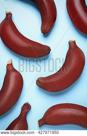 Tasty Red Baby Bananas On Light Blue Background, Flat Lay