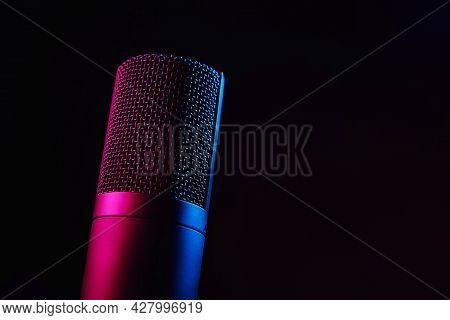 Studio Microphone On Dark Background With Copy Space. Black Professional Condencer Microphone With N