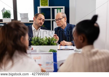 Focused Mixraced Professional Team Business People Work Together At Meeting Table. Multiethnic Colle