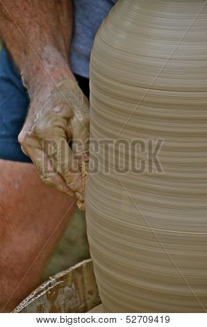 a lamp is being shaped as it turns on the potter's wheel