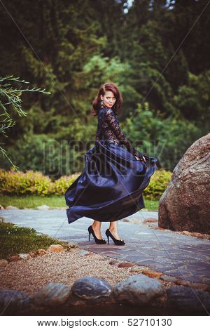 Passionate girl dancing in black dress