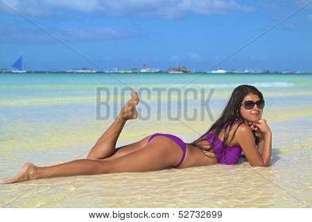 The beautiful girl in bikini on a beach