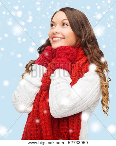 winter, people, happiness concept - happy woman in sweater, scarf and mittens