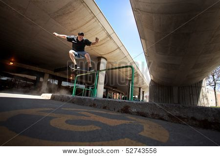Skateboarder Doing A Crooked Grind Trick On A Rail