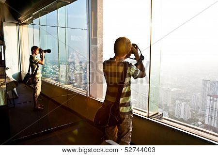 People Enjoying View Across Bangkok Skyline