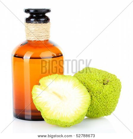 Osage Orange fruits (Maclura pomifera) and medicine bottle, isolated on white