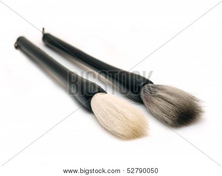 Two chinese calligraphic brushes on white background