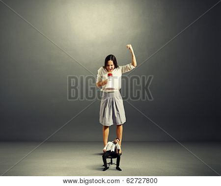 screaming businesswoman and tired small businessman over dark background