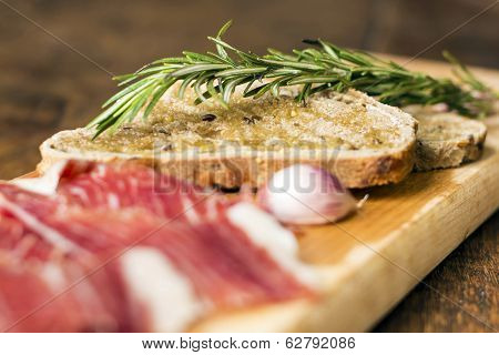 Bread Slices With Rosemary And Serrano Ham, Focus On Bread