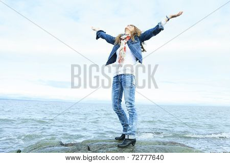 Woman edge of the ocean freedom