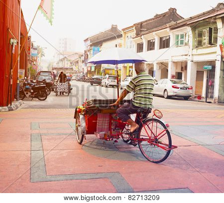 Malaysia, Penang, Georgetown - Circa Jul 2014: A Pedicab Driver Pedals His Cycle Rickshaw, Laden Wit
