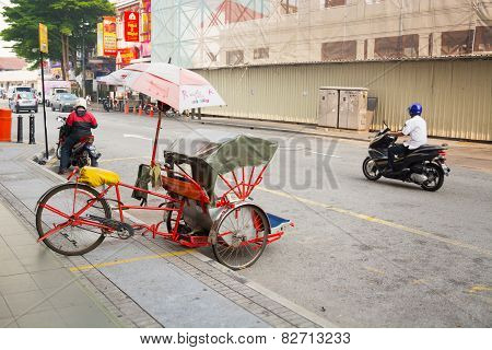 Malaysia, Penang, Georgetown - Circa Jul 2014: Pedicab Parked On The Curb Along A Typical Street In