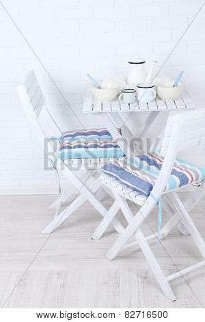 Wooden chairs and table in cozy kitchen