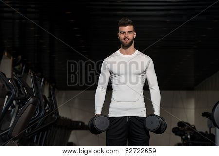 Handsome Man Exercising Biceps With Dumbbells