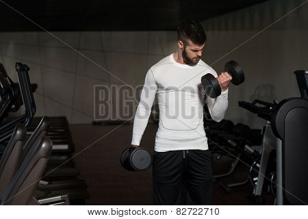 Healthy Young Man Doing Exercise For Biceps