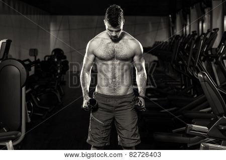 Handsome Man Exercising Biceps With Dumbbells