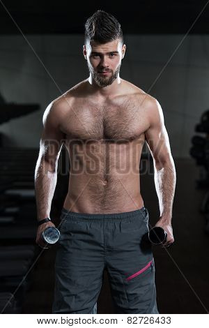 Young Man Exercising Biceps With Dumbbells
