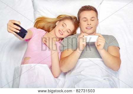 Beautiful young couple in bed