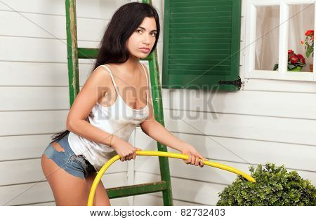 Woman Holding A Hose