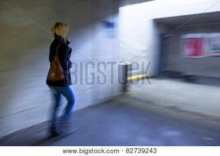 a young woman in an underpass for pedestrians fear of harassment and crime