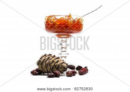 jam in a vase and pine cones