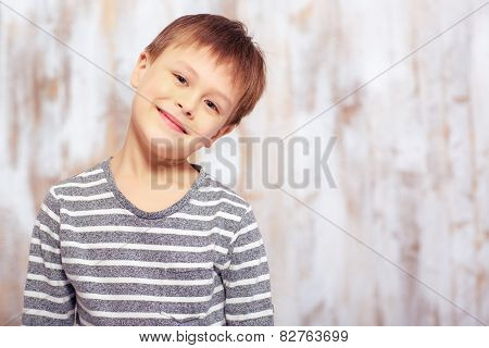 Portrait of a cute emotional little boy in bed