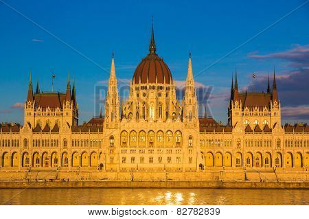 Budapest Parliament Building Illuminated During Sunset With Danube River, Hungary, Europe