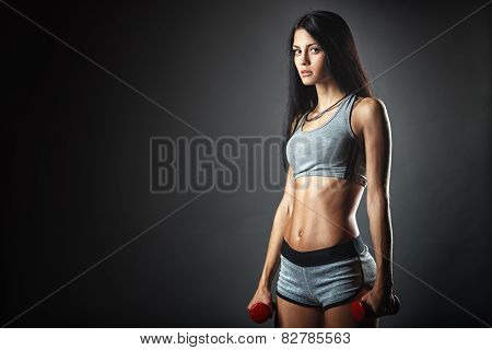 Sports young woman with dumbbells