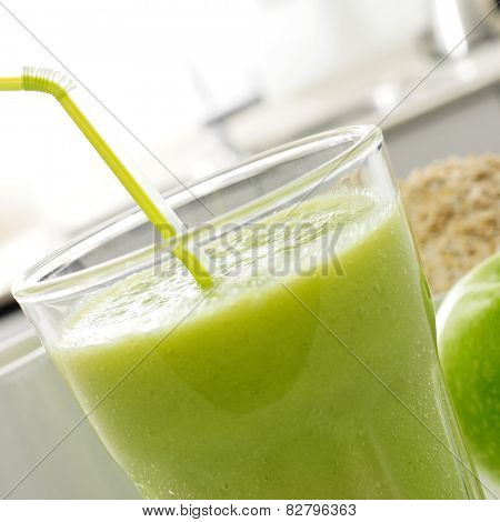 closeup of a glass with a fresh green smoothie for breakfast