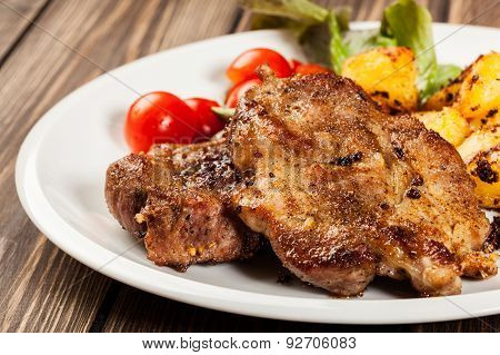 Steaks, Baked Potatoes And Vegetable Salad