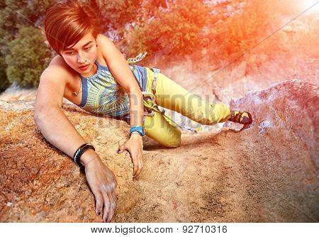 Rock climber climbing up a cliff
