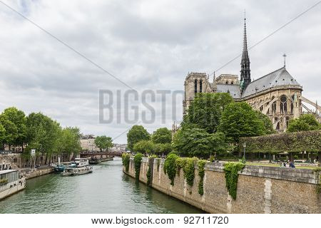 Tourists Around The Notre Dame Cathedral Along River Seine In Paris