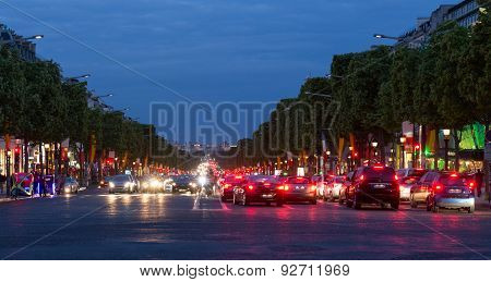 Evening Streetview With Illumination And Traffic At Champs Elysees, Paris