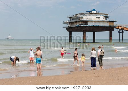 Seaside Visitors At Dutch Beach Near Pier Of Scheveningen
