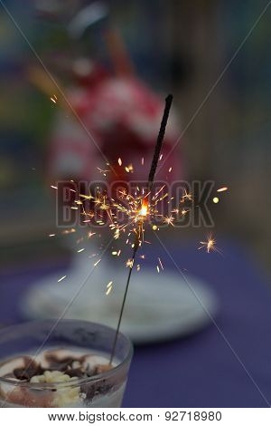 Festive Sparkels In An Ice Cream Cup On A Table With A Purple Table Cloth